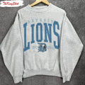 Gray sweatshirt with 'Detroit Lions' text and logo on a gray background
