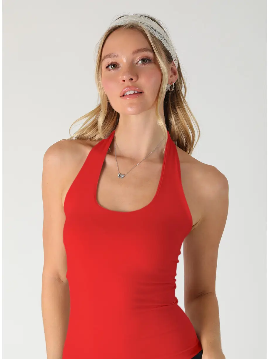 Woman wearing a red tank top against a white background